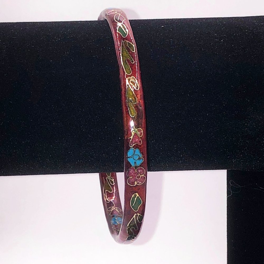 Deep red cloisonne bracelet with tones of gold, blue, green, and pink